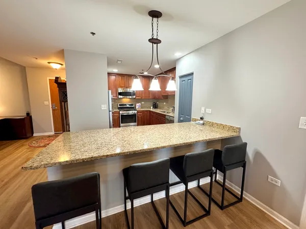 a dining table with chairs and wooden floor