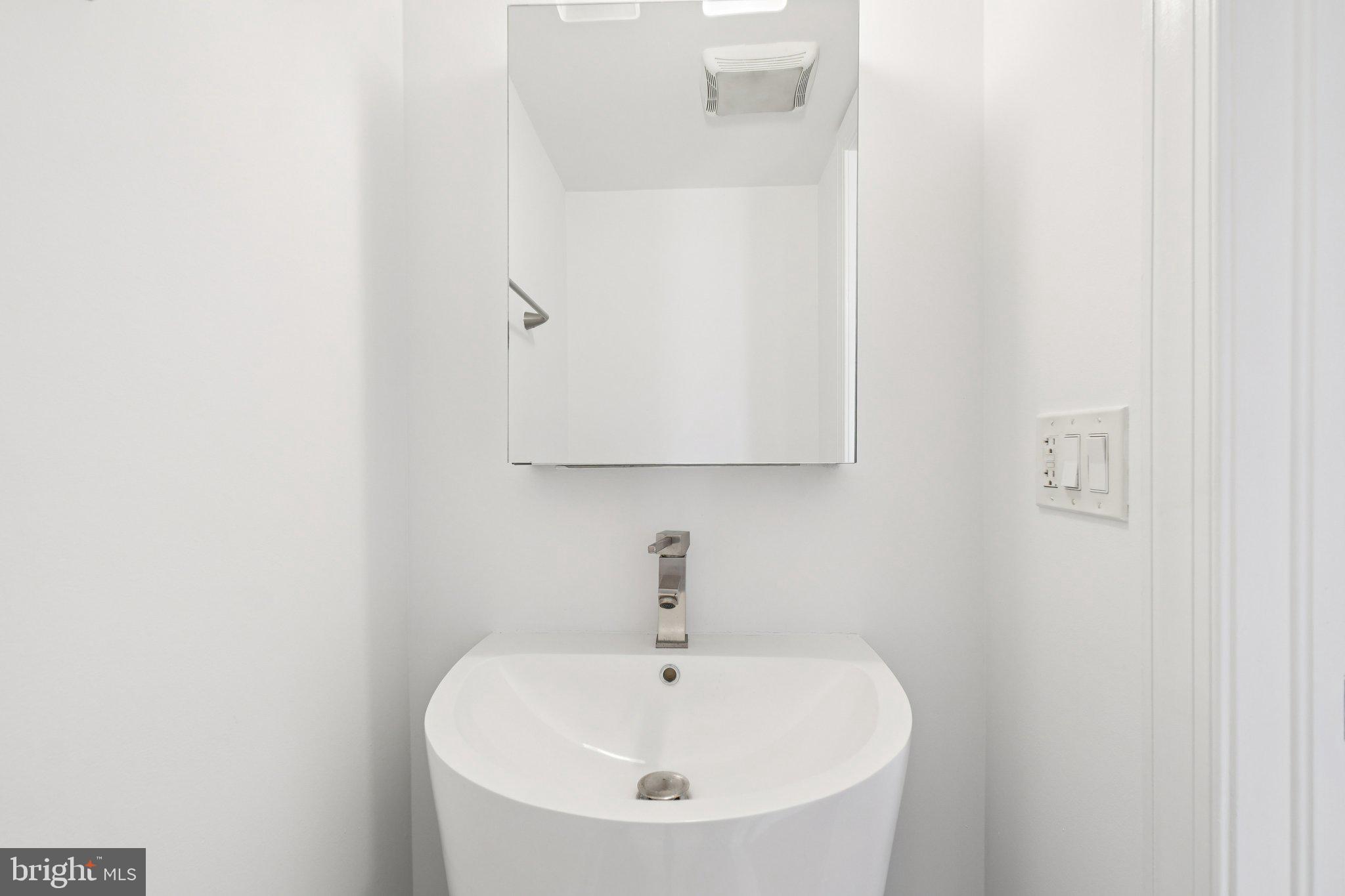 624 19th Street Northeast Washington, DC 20002 - Photo 13 of 29 a bathroom with a sink and a mirror