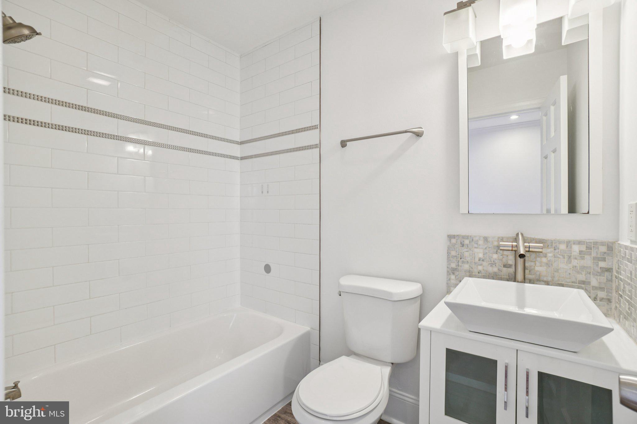 624 19th Street Northeast Washington, DC 20002 - Photo 24 of 29 a bathroom with a sink toilet and shower