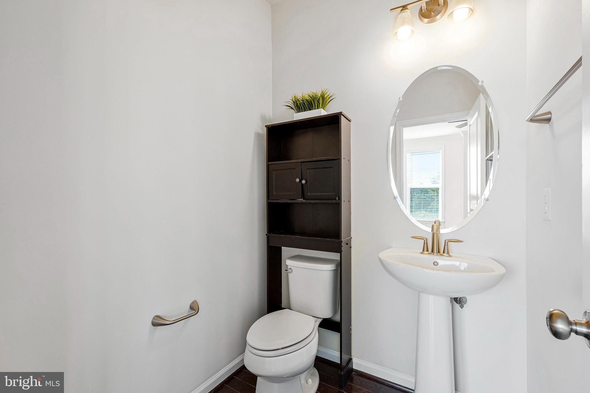 14580 Lakestone Drive Chantilly, VA 20151 - Photo 16 of 21 a bathroom with a toilet sink and mirror