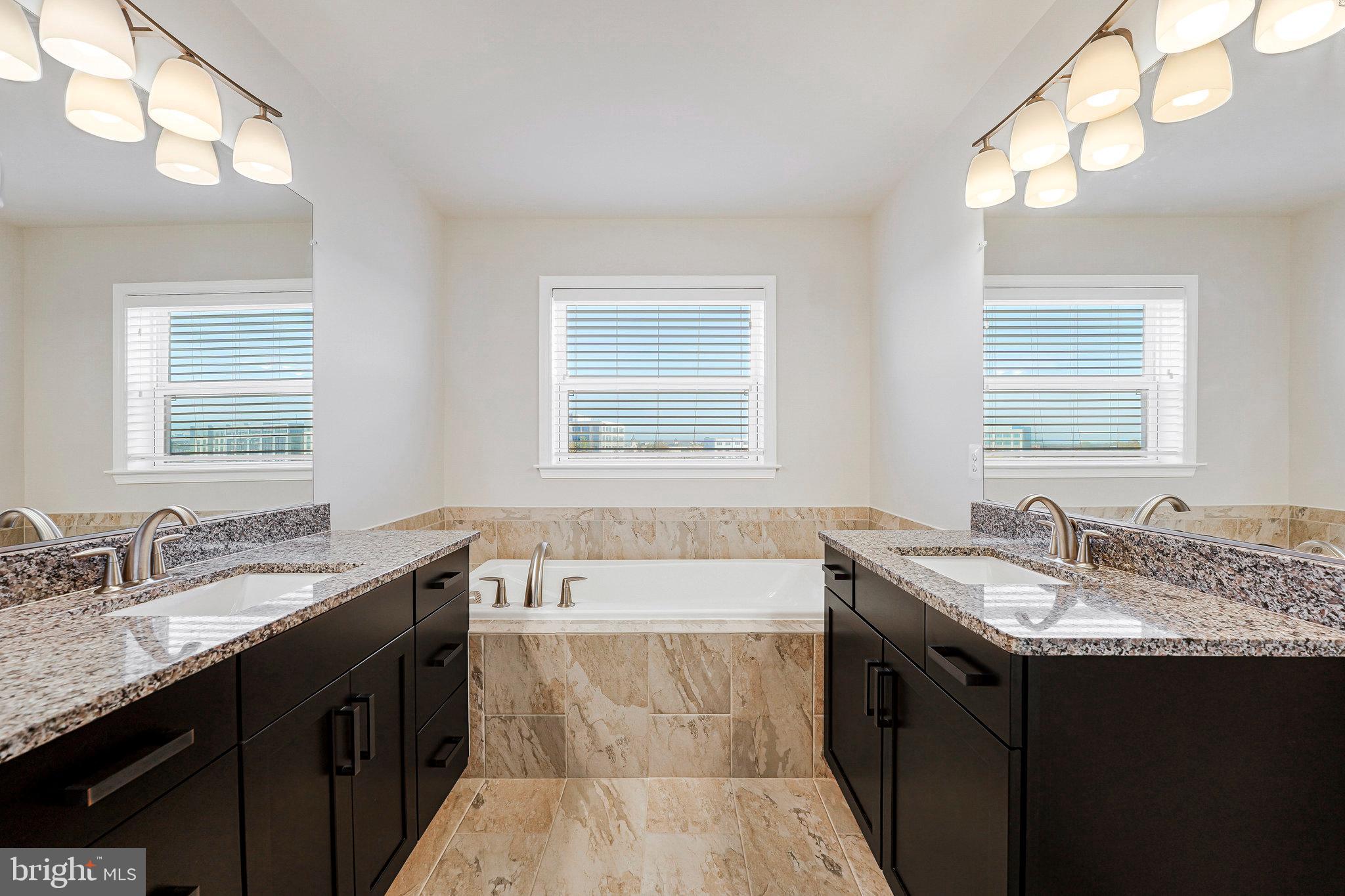 14580 Lakestone Drive Chantilly, VA 20151 - Photo 10 of 21 a bathroom with a granite countertop bathtub sink double vanity and mirror