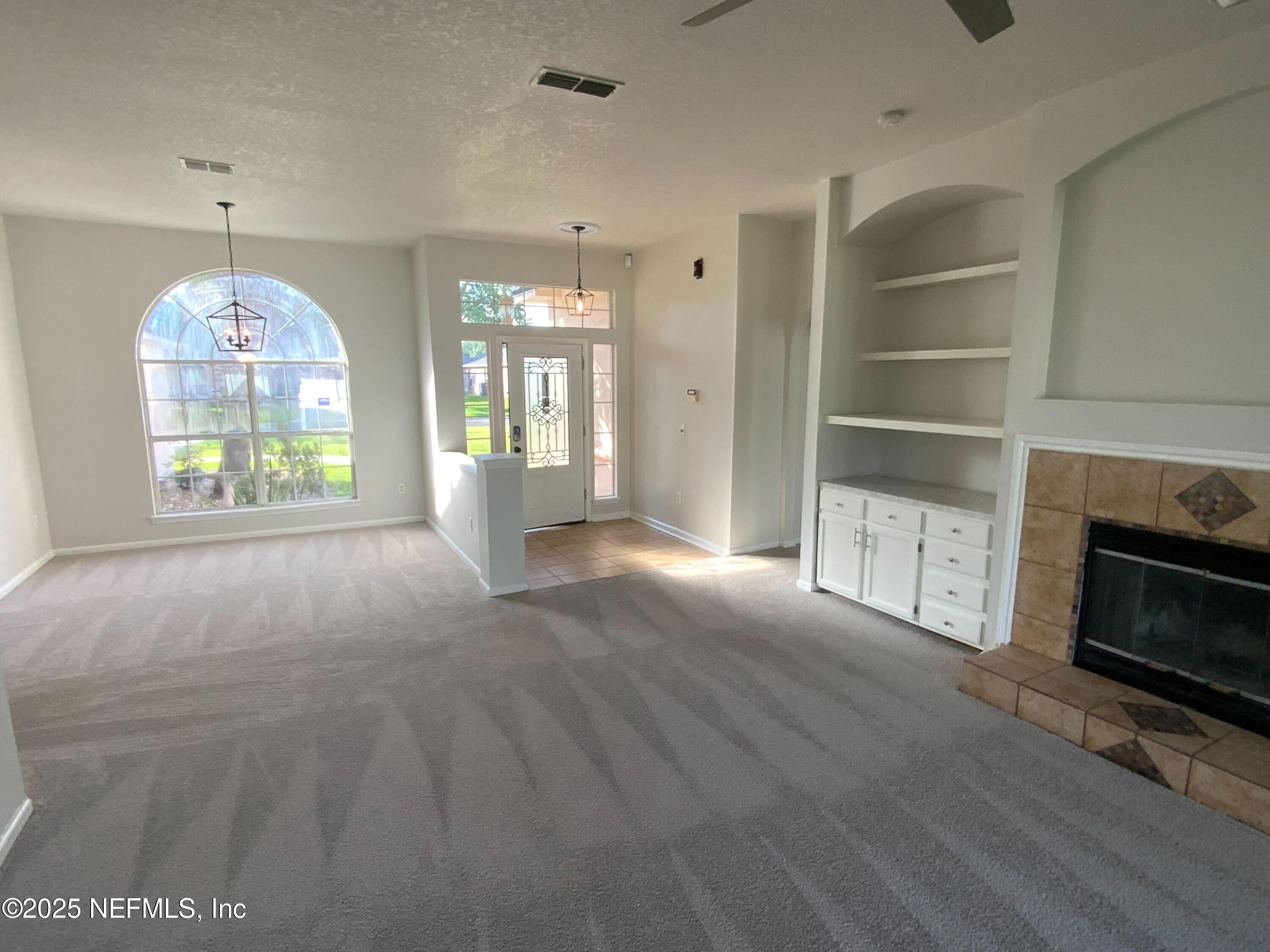 9767 Brockham Court Jacksonville, FL 32221 - Photo 14 of 17 a view of an empty room with a window and kitchen view