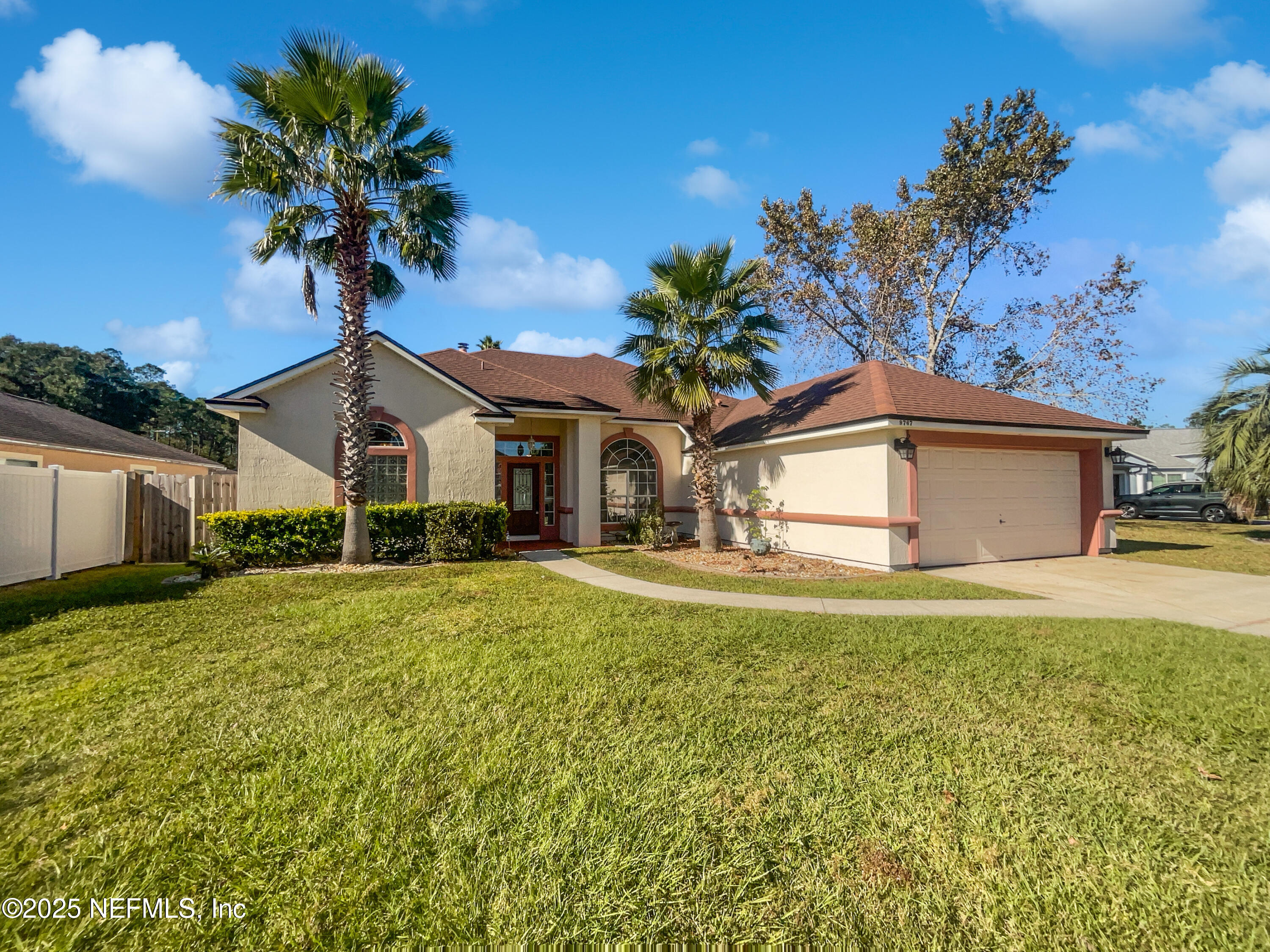 9767 Brockham Court Jacksonville, FL 32221 - Photo 4 of 17 a front view of a house with garden