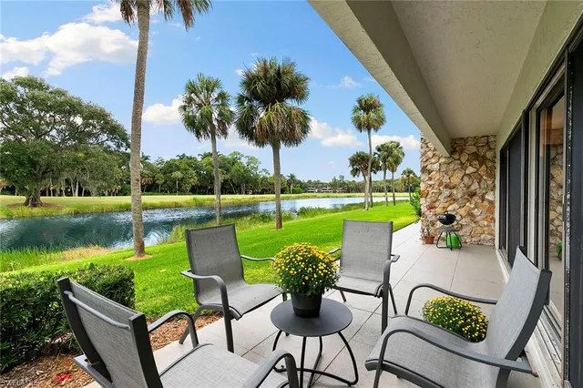 a view of a chairs and table in the patio and a lake view