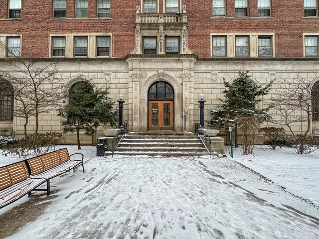 a view of a brick building with many windows