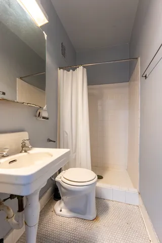 a bathroom with a sink toilet and shower