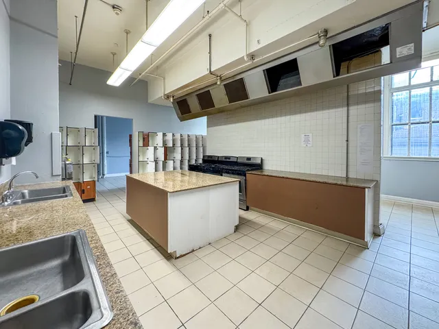 a kitchen with stainless steel appliances granite countertop a sink and a counter