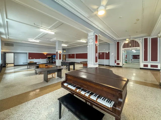 a living room with lots of furniture and a piano