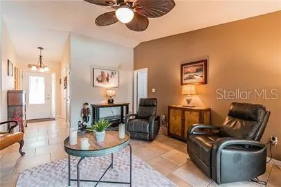 a living room with furniture chandelier and a fireplace