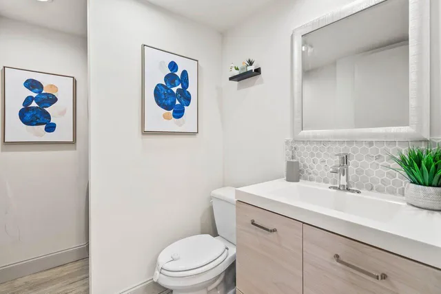 a bathroom with a sink a toilet and a mirror