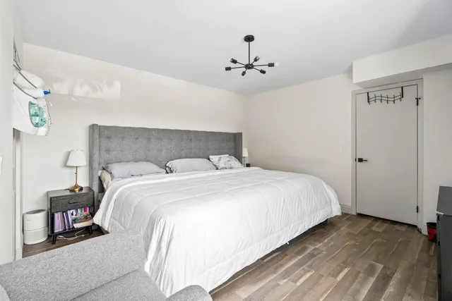 a bedroom with a bed and a chandelier