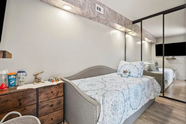 a bedroom with a bed and ceiling fan