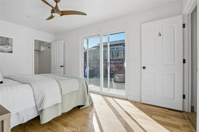 a spacious bedroom with a bed and a lamp