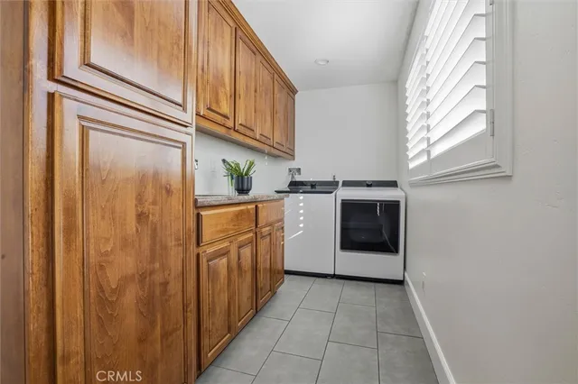 a utility room with cabinets dryer and washer