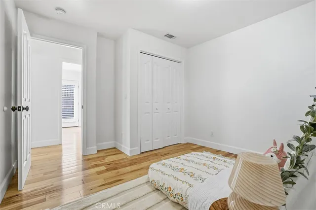 a bed sitting in a bedroom next to a window