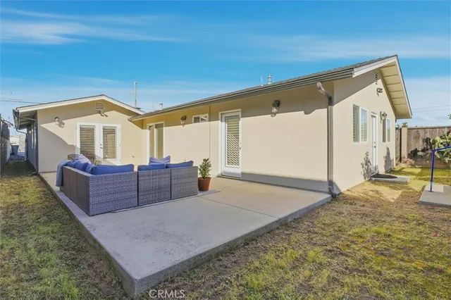 a view of a patio with table and chairs
