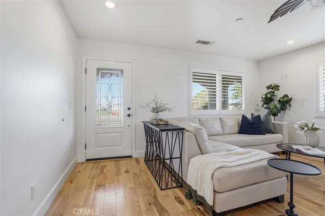 a living room with furniture and flowers