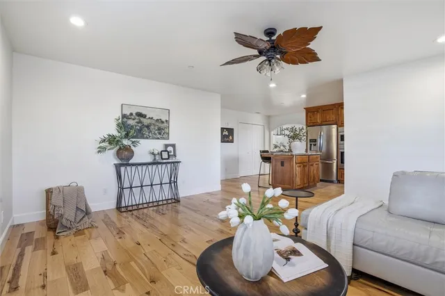 a living room with furniture and a wooden floor