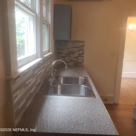 a view of walk in closet with empty room