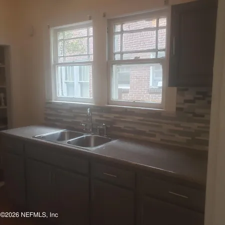 a kitchen with a sink and a window