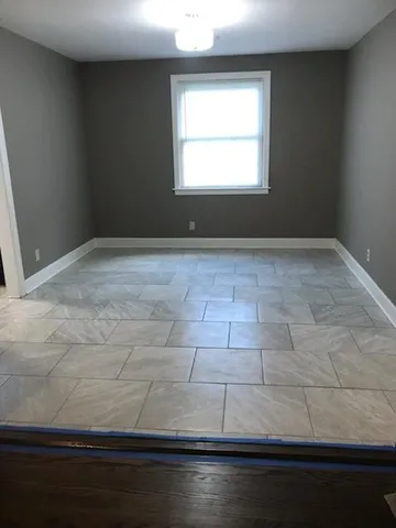 a view of wooden floor and windows in a room