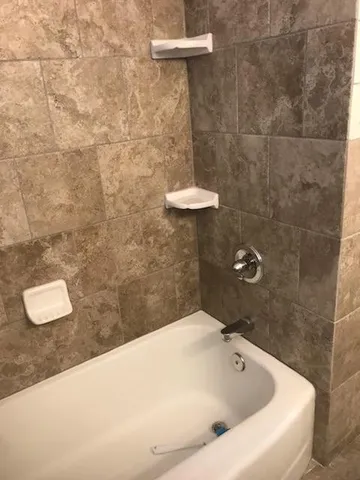 a bathroom with a white sink and a shower