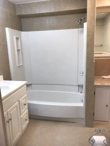 a bathroom with bathtub and shower