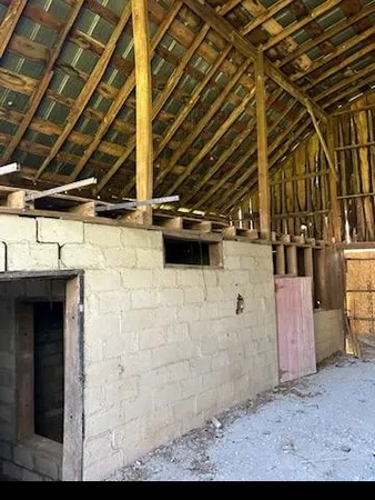 a view of an empty room with a kitchen