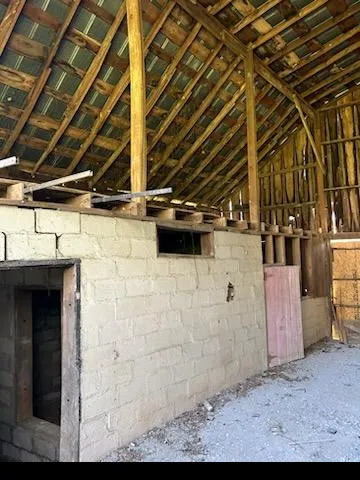 a view of an empty room with a kitchen