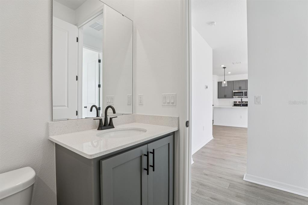 1658 Cane Bamboo Drive St. Cloud, FL 34771 - Photo 22 of 51 a bathroom with a sink and a mirror