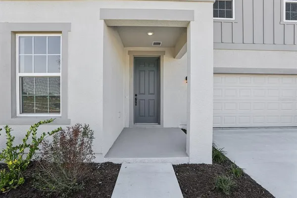 front view of a house with a potted plant