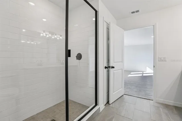 a bathroom with a glass shower door