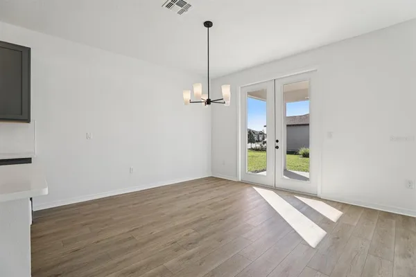 a view of a room with wooden floor and a window