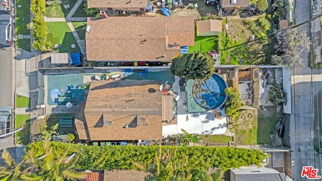 an aerial view of residential houses with city view