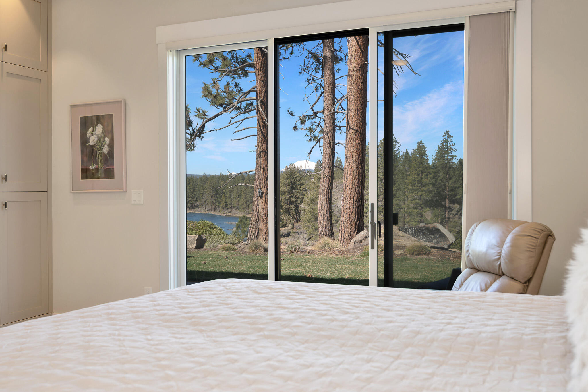 60871 River Rim Drive Bend, OR 97702 - Photo 24 of 42 a bedroom with a bed and glass window