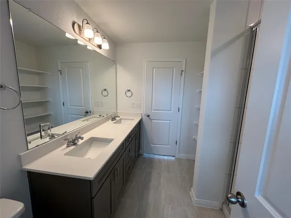 a bathroom with a glass shower door