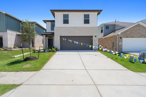 a kitchen with cabinets stainless steel appliances a sink and wooden floor