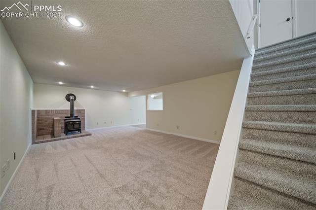 263 Southpark Road Highlands Ranch, CO 80126 - Photo 29 of 42 Walkout basement boasts large tv / game room with wood burning stove