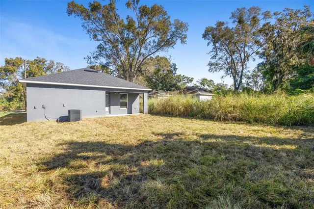 a front view of house with yard and lake view