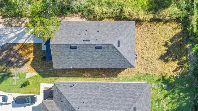 an aerial view of a house with yard swimming pool and outdoor seating