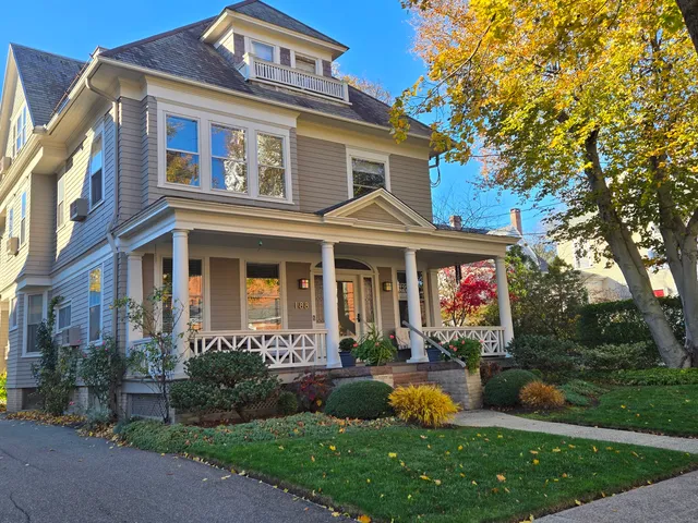 a front view of a house with garden and outdoor seating