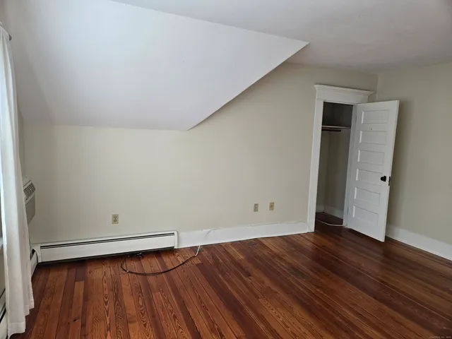 an empty room with wooden floor