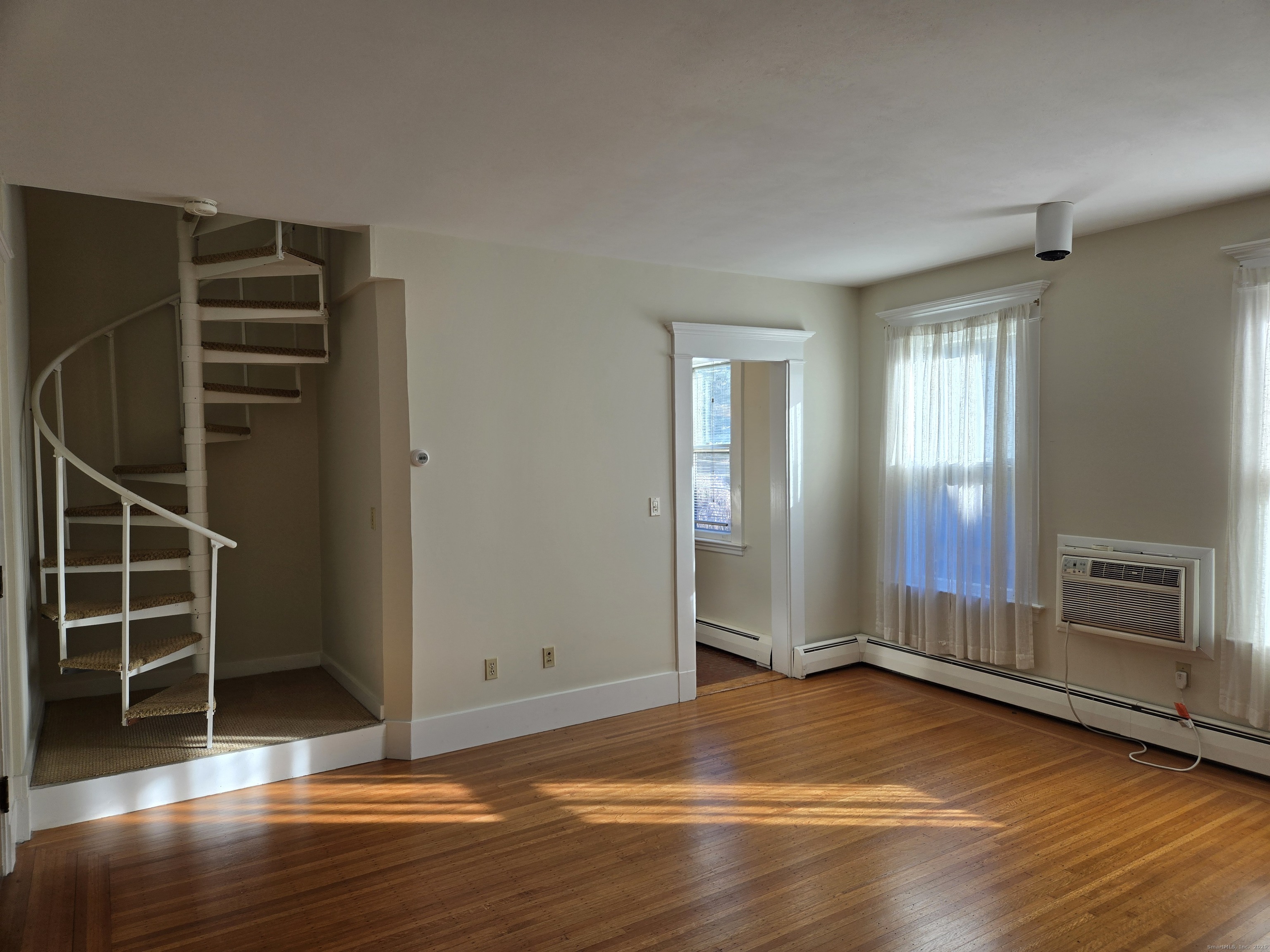188 Cold Spring Street, Unit 4 New Haven, CT 06511 - Photo 5 of 18 an empty room with wooden floor closet and windows