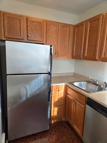 a kitchen with a refrigerator and a sink