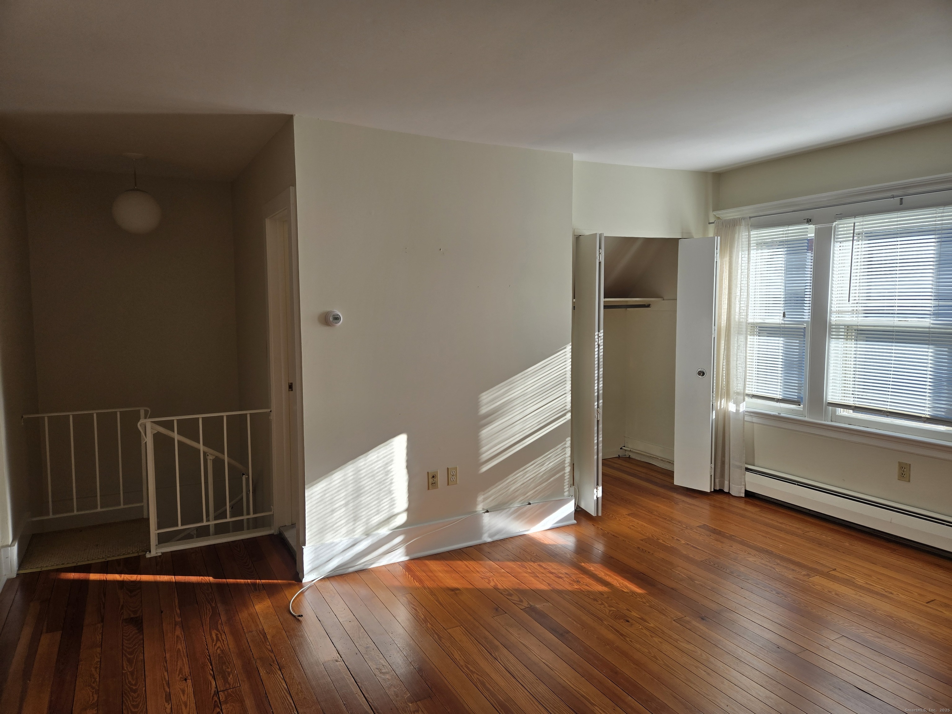 188 Cold Spring Street, Unit 4 New Haven, CT 06511 - Photo 10 of 18 an empty room with wooden floor and windows