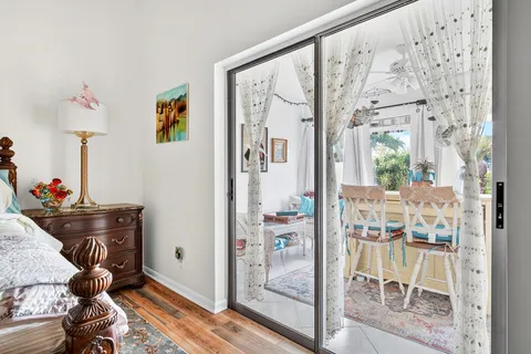 a living room with furniture and a painting on the wall