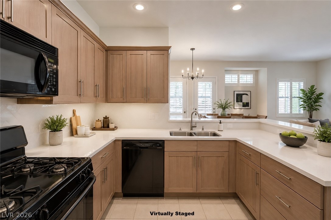 1479 Orange Jubilee Road Henderson, NV 89014 - Photo 9 of 36 Culinary delights await in this contemporary kitchen, boasting ample counter space and warm wooden cabinetry.