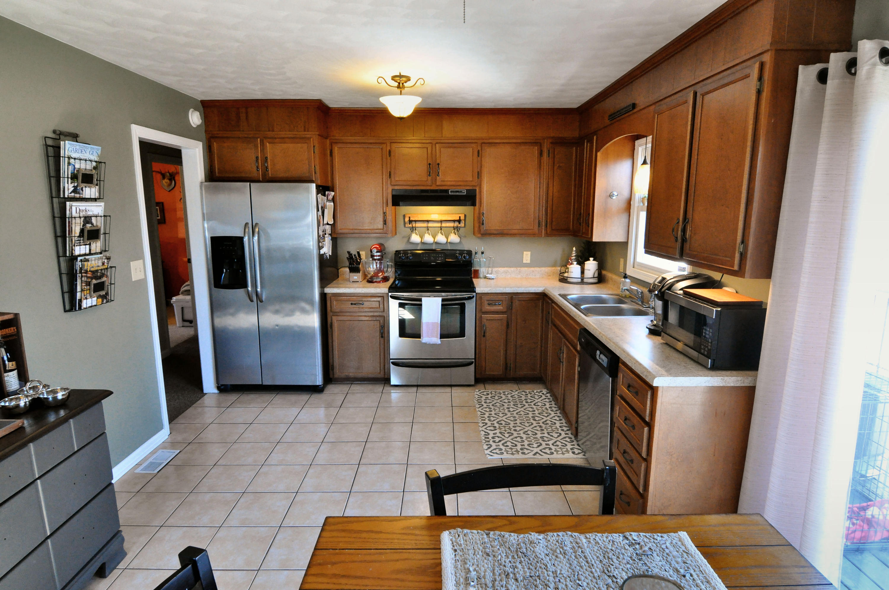 2750 Sandy Level Road Goodview, VA 24095 - Photo 11 of 20 a kitchen with granite countertop a refrigerator and a stove top oven