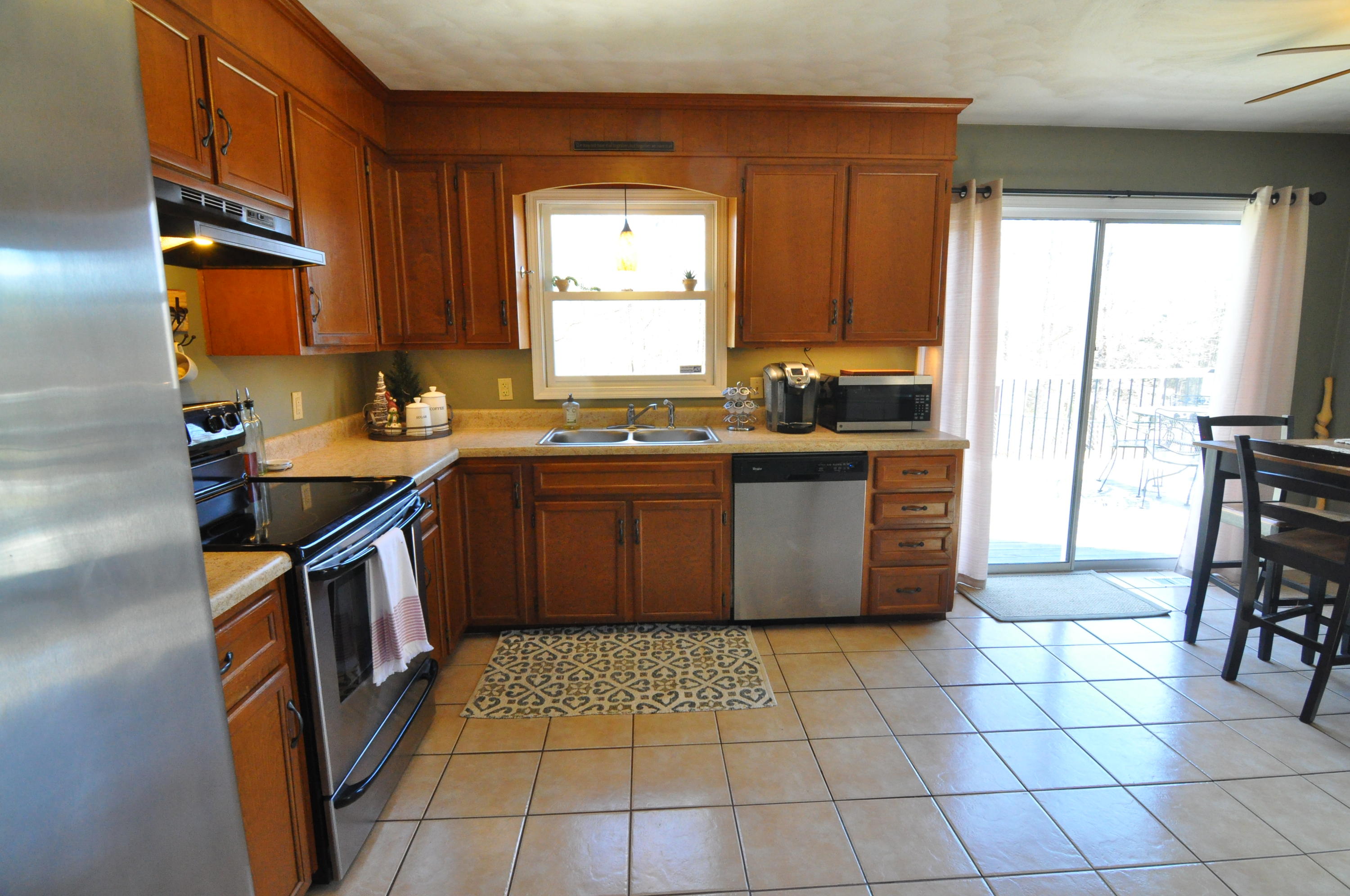 2750 Sandy Level Road Goodview, VA 24095 - Photo 14 of 20 a kitchen with a sink a stove top oven a counter space and a window