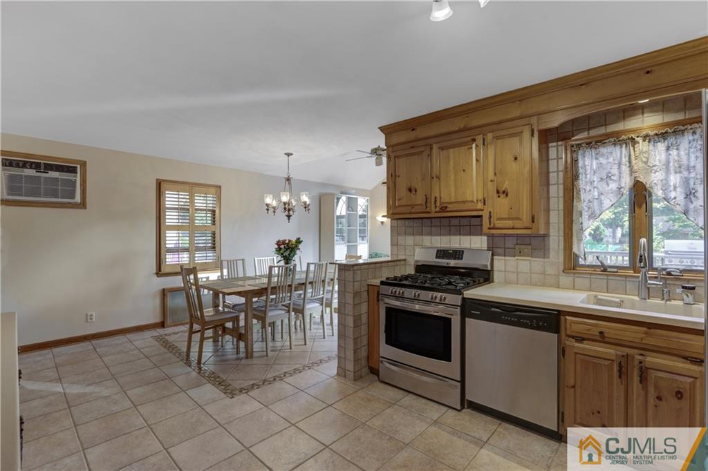 73 Ramsey Road Middlesex, NJ 08846 - Photo 11 of 25 a kitchen with a stove a sink and a refrigerator